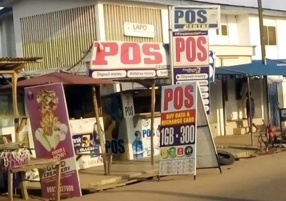 A high-quality POS terminal with a successful transaction receipt and Naira notes, showing a modern agency banking setup in Nigeria.